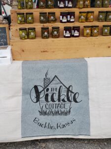 Pickle Cottage sign at a booth display.
